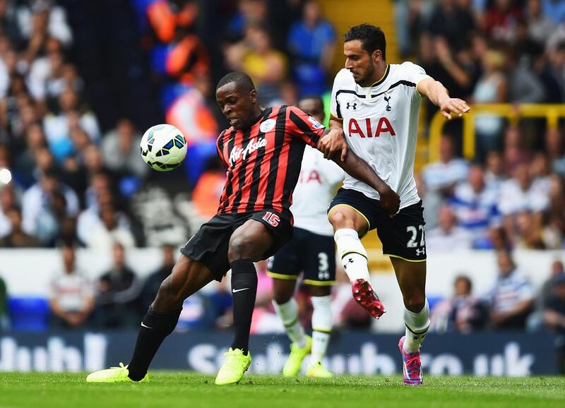 Nacer Chadli, right, of Tottenham Hotspur challenges Nedum Onuoha of Queens Park Rangers during their Premier League match at White Hart Lane on August 24, 2014, in London. Jamie McDonald / Getty Images