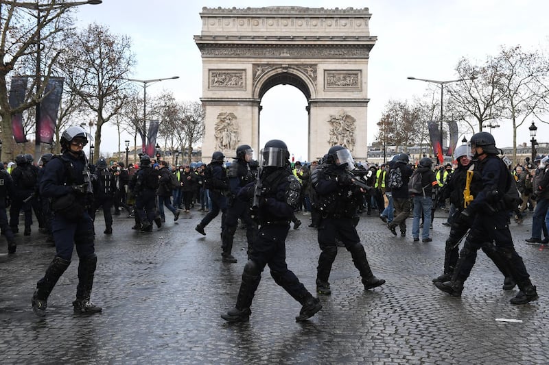 French police stand gaurd as demonstrators take part in the demonstration of the yellow vests at the Arc de Triomphe. Getty Images
