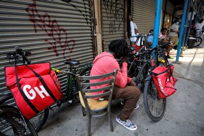 Riders for Grubhub food delivery service congregate between deliveries in midtown Manhattan, New York. Reuters