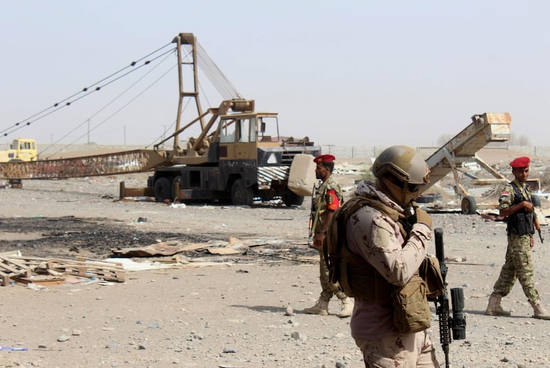 Soldiers with a military coalition in Yemen backed by Saudi Arabia and the United Arab Emirates stand guard outside a damaged warehouse of Yemen's Red sea mills company in the port city of Hodeida on January 22, 2019.

 Gunshots reverberate through a battle-scarred granary in the lifeline port city of Hodeida, where a mountain of grain meant for starving Yemenis remains inaccessible as a hard-won ceasefire comes under intense strain. The Red Sea mills, one of the last positions in Hodeida seized by Saudi and Emirati-backed Yemeni forces before last month's UN-brokered truce, holds enough wheat to feed nearly four million people for a month in a country on the brink of famine.
 / AFP / Saleh Al-OBEIDI
