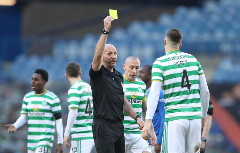 Soccer Football - Scottish Premiership - Rangers v Celtic - Ibrox, Glasgow, Scotland, Britain - January 2, 2021 Celtic's Shane Duffy is shown a yellow card by referee Bobby Madden REUTERS/Russell Cheyne