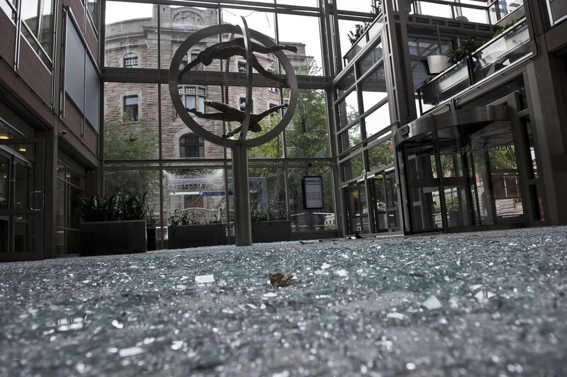 A picture shows the damages at the entrance of Norwegian newspaper VG building in Oslo on July 23, 2011 next to the government headquarters building area, a day after twin attacks here and on a youth camp, Norway's deadliest post-war tragedy. At least 91 people died in a shooting at a summer school meeting organised by the ruling Labour Party on Utoeya, an island outside the capital, while seven were killed when a powerful bomb ripped through central Oslo, where the prime minister's office and several government buildings are located.          AFP PHOTO / SCANPIX / Aleksander ANDERSEN
NORWAY OUT
 *** Local Caption ***  476231-01-08.jpg