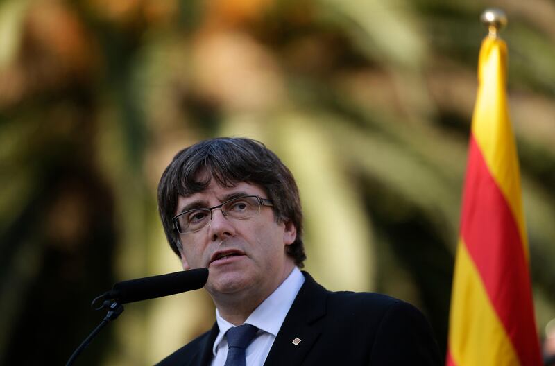 Catalan regional President Carles Puigdemont addresses to the media after a ceremony commemorating the 77th anniversary of the death of Catalan leader Lluis Companys at the Montjuic Cemetery in Barcelona, Spain, Sunday, Oct. 15, 2017. Catalonia's president is facing a critical decision that could determine the course of the region's secessionist movement to break away from Spain. The Spanish government has given Carles Puigdemont until Monday morning to clarify if he did or didn't actually declare independence earlier this week.(AP Photo/Manu Fernandez)