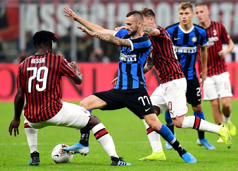 Inter Milan's Croatian defender Marcelo Brozovic challenges AC Milan's Ivorian midfielder Franck Kessie. AFP