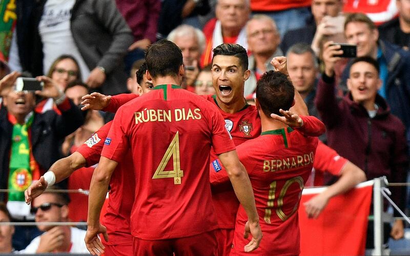 Ronaldo is congratulated by his teammates. AP Photo