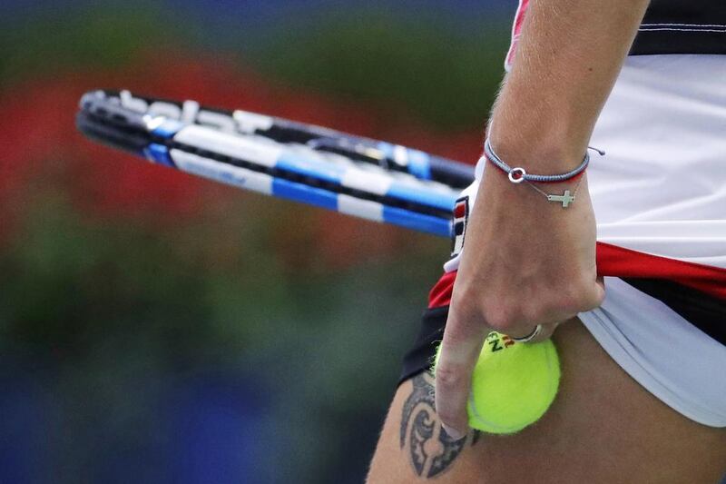 Karolina Pliskova, of the Czech Republic, tucks a ball under her skirt before serving to Angelique Kerber. Julio Cortez / AP Photo