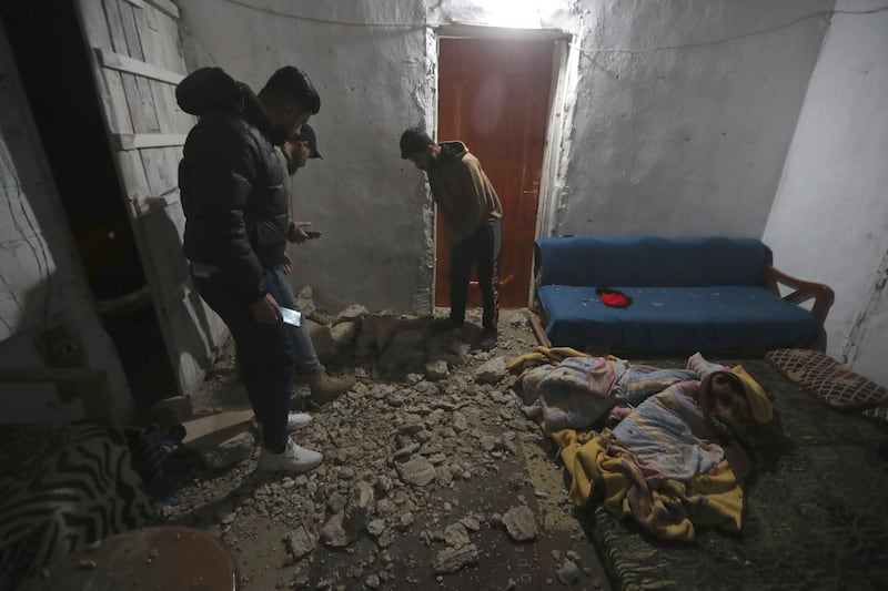 Lebanese residents examine the damage at a house after air strikes in Qalili village in south Lebanon. AP