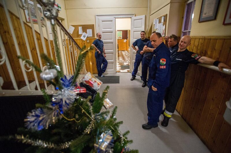 Firefighters smile after decorating their Christmas tree at the Central Station of Disaster Management in Budapest, Hungary.  EPA/Zoltan Balogh