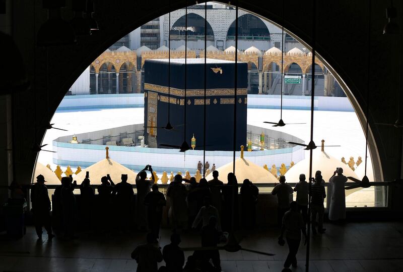 Worshippers take photographs of the Kaaba inside Mecca's Grand Mosque a day after Saudi authorities emptied Islam's holiest site for sterilisation over fears of the new coronavirus COVID-19. AFP