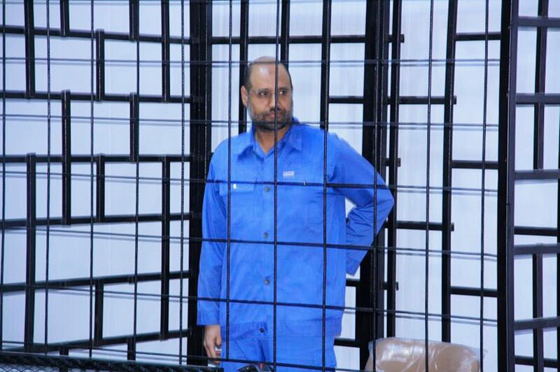 Saif al-Islam Gaddafi, son of late Libyan leader Muammar Gaddafi, attends a hearing behind bars in a courtroom in Zintan, June 22, 2014 . REUTERS/Stringer (LIBYA - Tags: POLITICS CIVIL UNREST  CRIME LAW) - GM1EA6M1S1801
