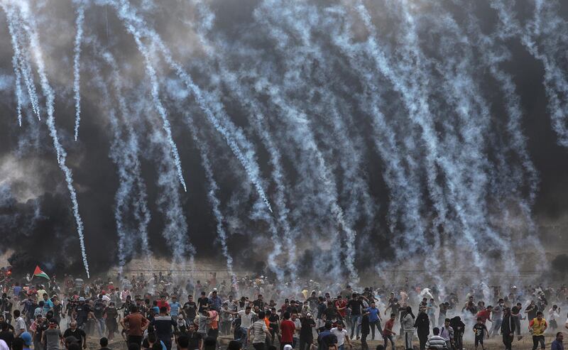Israeli army soldiers fire tear-gas at Palestinians protesters during clashes after Friday protests near the border with Israel in eastern Gaza City. Mohammed Saber / EPA