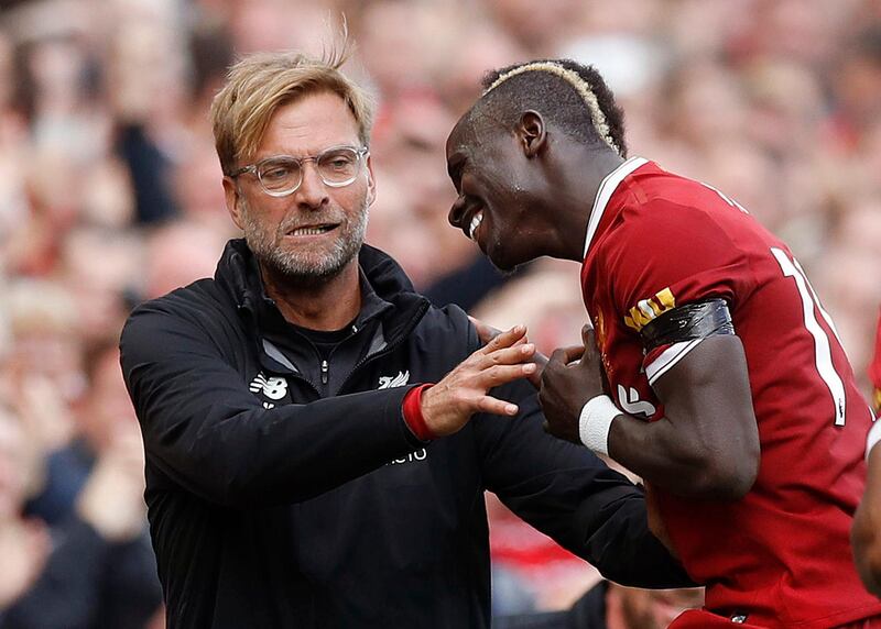 Liverpool's Sadio Mane, right, celebrates his goal with manager Jurgen Klopp, during the English Premier League soccer match between Liverpool and Crystal Palace, at Anfield, in Liverpool, England, Saturday Aug. 19, 2017. (Martin Rickett/PA via AP)