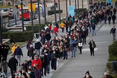 People queue to receive a vaccine in Barcelona, in Spain's hard-hit Catalonia region. EPA 