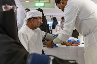 A Hajj pilgrim has his blood pressure tested before boarding his flight at Dubai International Airport. Antonie Robertson / The National