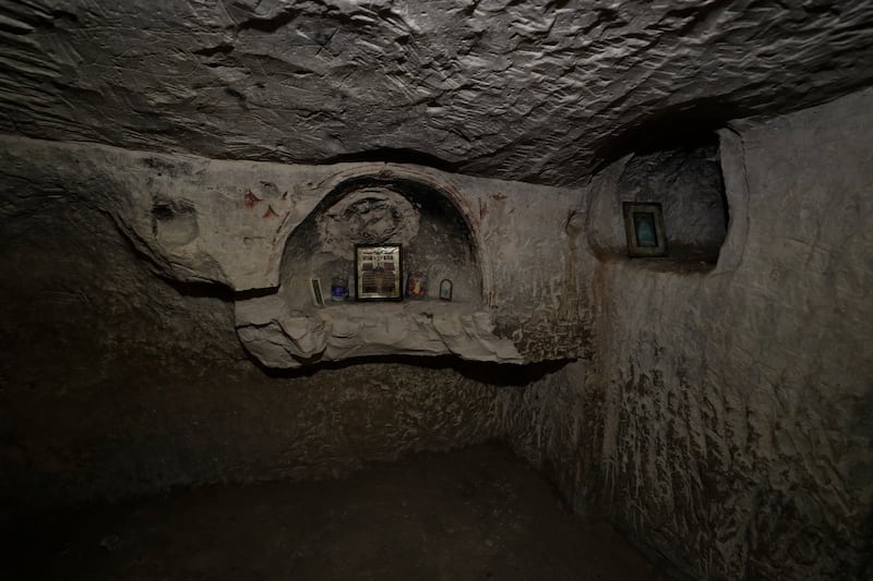 Christian religious icons left by recent visitors are placed in a niche of the cave. EPA