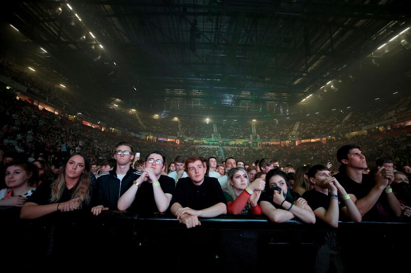 People look at the stage during the 'We Are Manchester' benefit show amid heightened security at the re-opening of the Manchester Arena, Saturday Sept. 9, 2017, for the first time since the terror attack by suicide bomber Salman Abedi who detonated his device in the foyer of the venue at the end of an Ariana Grande concert, killing 22 and injuring scores of others on May 22, in Manchester, England. (Peter Byrne/PA via AP)