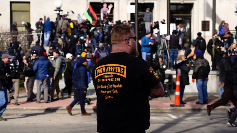 A man in an Oath Keepers shirt stands outside the Kenosha County Courthouse in Wisconsin, the day Kyle Rittenhouse was acquitted of all charges after pleading self-defence in the Kenosha shootings. AP