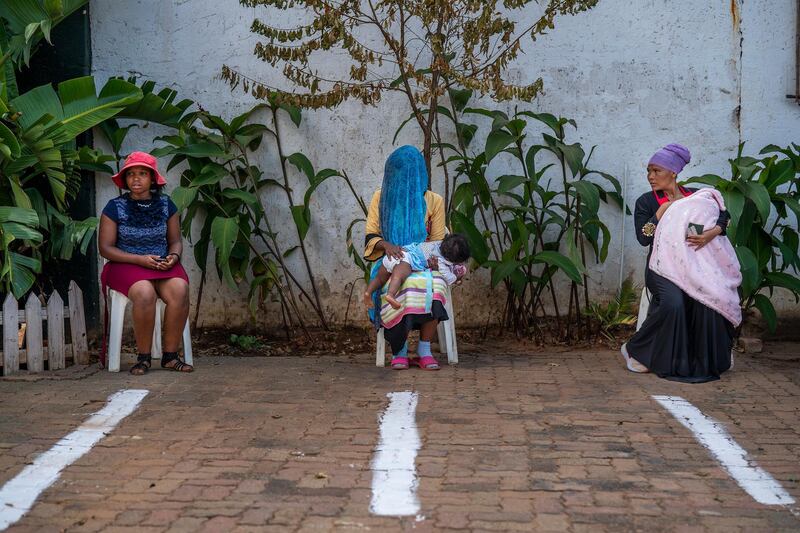 Three women wait to receive Ramadan sweets at the Imam Ahmed Raza Jaame Masjid mosque in Springs, south west of Johannesburg. AP