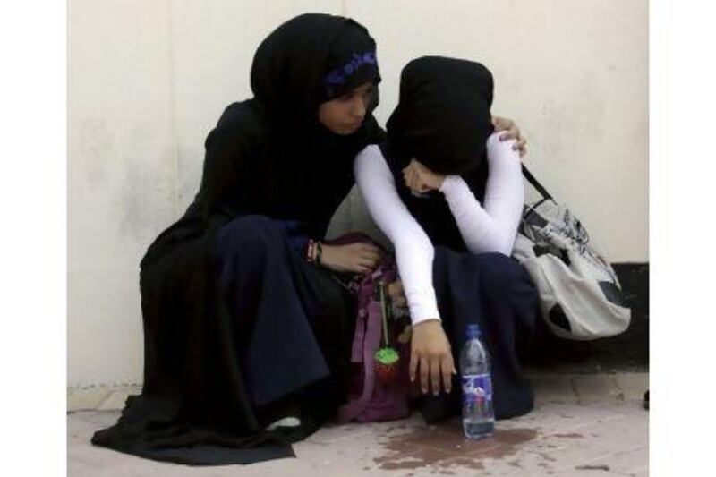 Students react at Saar High School for Girls, in Saar, after political fighting broke out at the school, west of the capital of Manama.