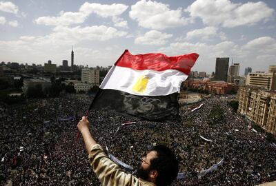 An Egyptian protester waves his national flag as tens of thousands gather for a demonstration at Cairo's Tahrir Square in April 2011. AFP