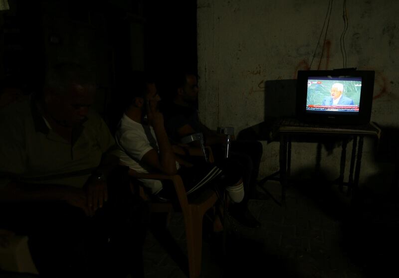 Palestinians watch a television broadcast of President Mahmoud Abbas's speech in the central Gaza Strip. Reuters