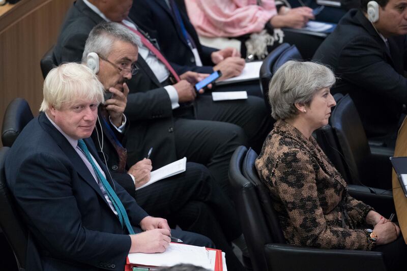 British Prime Minister Theresa May, right, and Foreign Secretary Boris Johnson attend a high level meeting, Wednesday, Sept. 20, 2017 at United Nations headquarters. (AP Photo/Mary Altaffer)