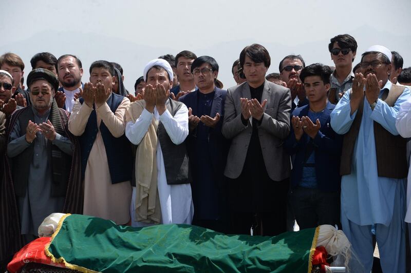 Afghan Shiite mourners offer funeral prayers for nine victims of a suicide attack in Kabul on August 16, 2018. - Gunmen launched an attack on an intelligence training centre in Kabul on August 16, officials said, just a day after a suicide bomber killed dozens of students in the war-weary Afghan capital. (Photo by NOORULLAH SHIRZADA / AFP)