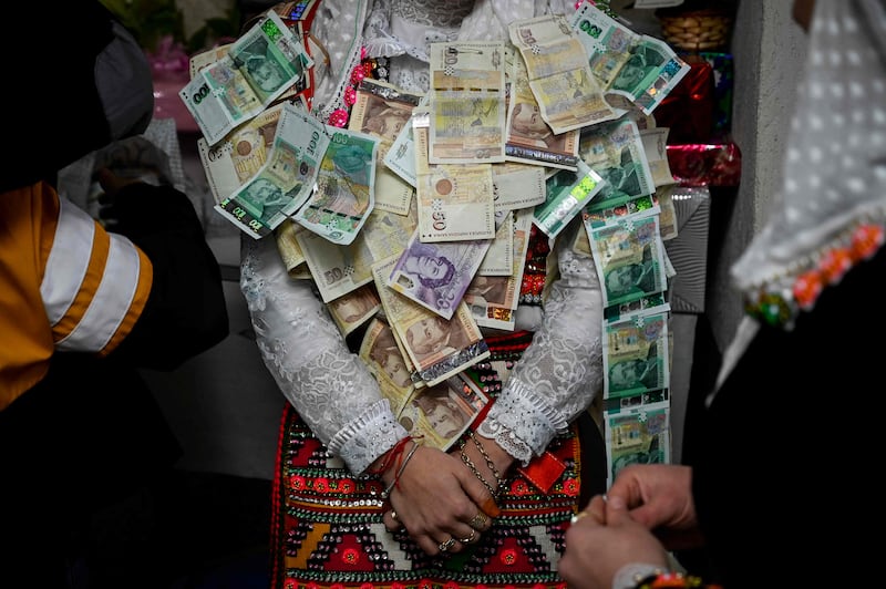 The bride is covered in money. AFP