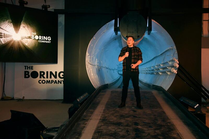 FILE - In this Dec. 18, 2018 file photo Elon Musk, co-founder and chief executive officer of Tesla Inc., speaks during an unveiling event for the Boring Co. Hawthorne test tunnel in Hawthorne, Calif. The Boring Company, backed by tech billionaire Musk has been granted a nearly $49 million contract to build a transit system using self-driving vehicles underneath the Las Vegas Convention Center. (Robyn Beck/Pool Photo via AP, File)