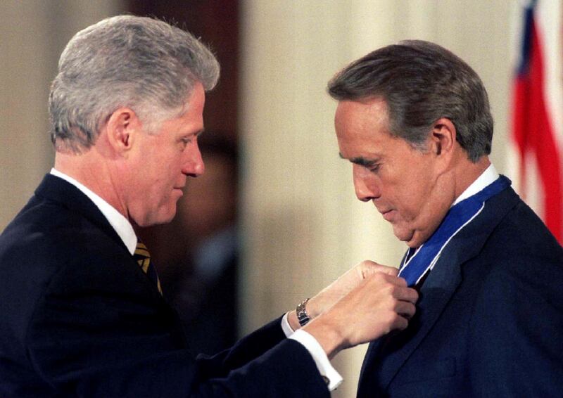 US President Bill Clinton confers the Presidential Medal of Freedom, the nation's highest civilian award, to Dole in January 1997. Reuters