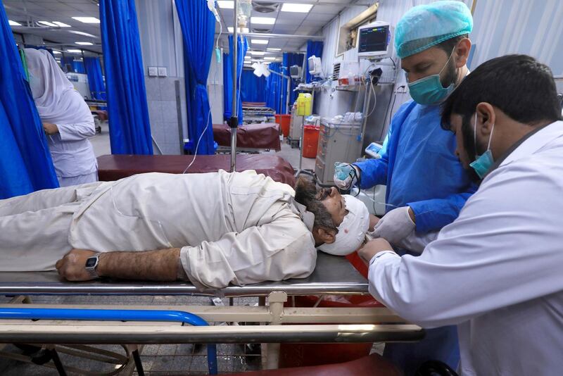 Medics give first aid to a person who was injured during a bomb blast at a religious seminary, at a hospital in Peshawar, Pakistan October 27, 2020. REUTERS/Fayaz Aziz