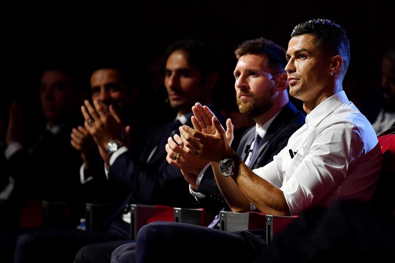 MONACO, MONACO - AUGUST 29: Cristiano Ronaldo of Juventus and Lionel Messi of FC Barcelona react during the UEFA Champions League Draw, part of the UEFA European Club Football Season Kick-Off 2019/2020 at Salle des Princes, Grimaldi Forum on August 29, 2019 in Monaco, Monaco. (Photo by Valerio Pennicino - UEFA/UEFA via Getty Images)