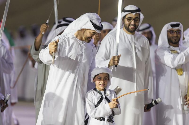 Sheikh Mohammed bin Zayed, Sheikh Tahnoon and Sheikh Rashid bin Saud dance during the 45th UAE National Day celebrations held at Adnec. Philip Cheung / Crown Prince Court — Abu Dhabi