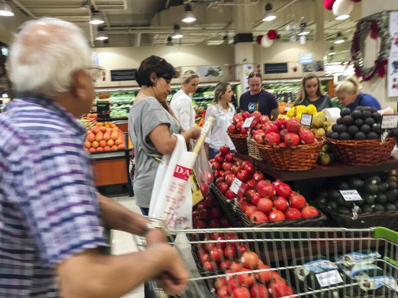 DUBAI, UNITED ARAB EMIRATES. 21 DECEMBER 2017. Shopping in Dubai Mall before the implementation of VAT across the UAE. Shoppers pick out produce at Waitrose. (Photo: Antonie Robertson/The National) Journalist: None. Section: National.