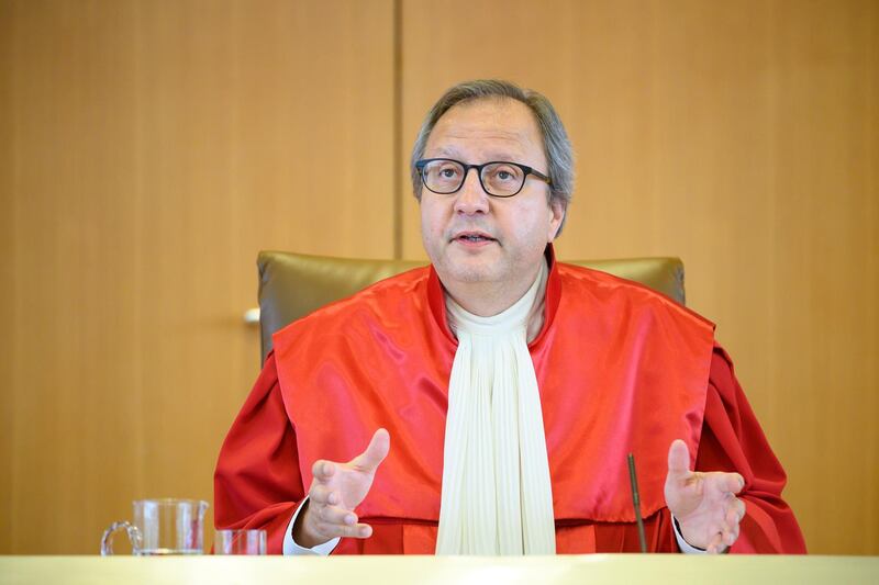 Andreas Vosskuhle, Chairman of the Second Senate of Germany's Federal Constitutional Court, announces the decision about the European Central Bank's (ECB) purchases program of government bonds at the court in Karlsruhe, Germany, Tuesday, May 5, 2020. Germany's Constitutional Court has ruled that the country's central bank must stop participating in a key European Central Bank stimulus program but gave the ECB time to demonstrate that the stimulus program is needed and appropriate. (Sebastian Gollnow/dpa via AP)