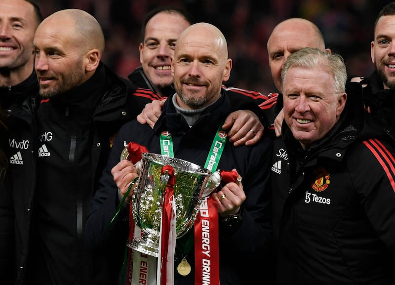 Manchester United manager Erik ten Hag with coaching staff celebrate with the trophy. Reuters 