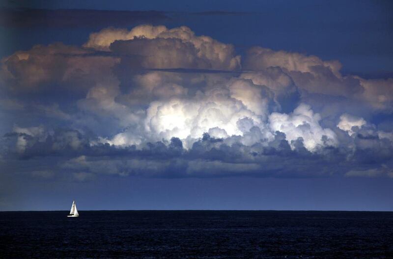 A storm cloud can be seen behind a yacht as it sails off the coast of Sydney. The Bureau of Meteorology last week forecast ‘warmer and drier than usual’ weather extending well into winter for Sydney and most of south-eastern Australia over the next three months. David Gray / Reuters