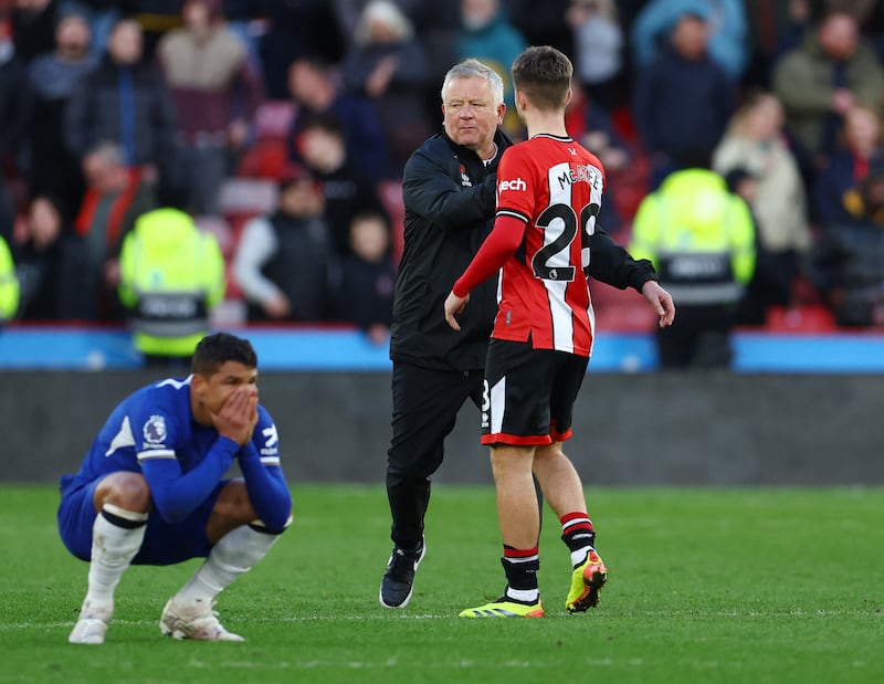 Sheffield United manager Chris Wilder shakes hands with James McAtee as Thiago Silva falls to his haunches. Reuters 