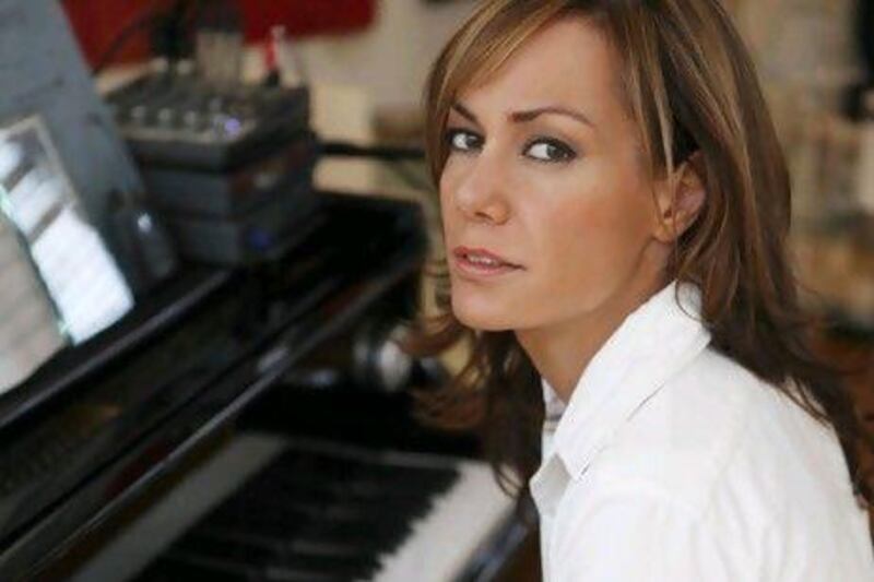 Tara Palmer-Tomkinson at her baby grand piano in her London penthouse. Alexander James