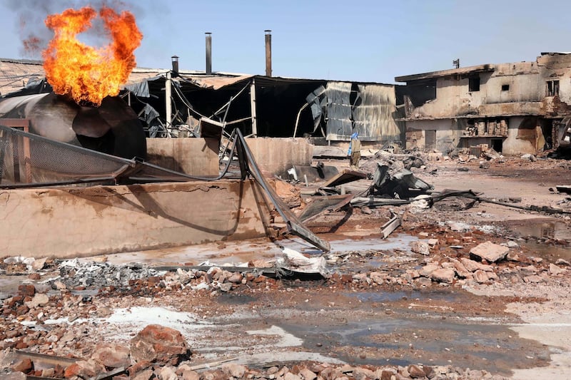 epa08041551 Flames rise from a tile manufacturing unit after an explosion in an industrial zone, north Khartoum, Sudan, 03 December 2019. According to media reports quoting medical sources, at least 15 people were killed and more than 90 injured in an explosion at tile factory in Khartoum. The cause of explosion was not immediately clear.  EPA/MARWAN ALI