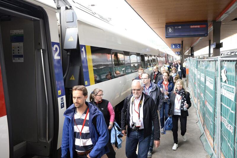 The ticket winners for the first train through the Gotthard tunnel get ready to board. Urs Flueeler / EPA