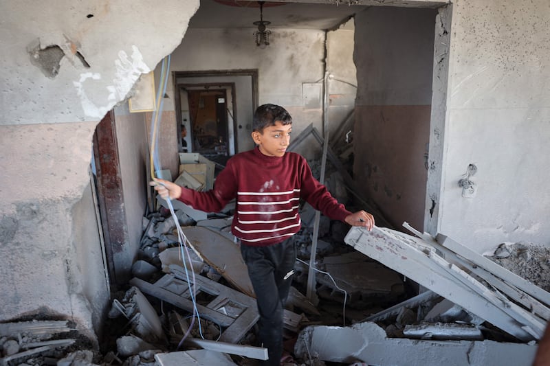 A Palestinian child walks through the rubble of a house hit by overnight Israeli bombing in Rafah, in the southern Gaza Strip, on Saturday. AFP