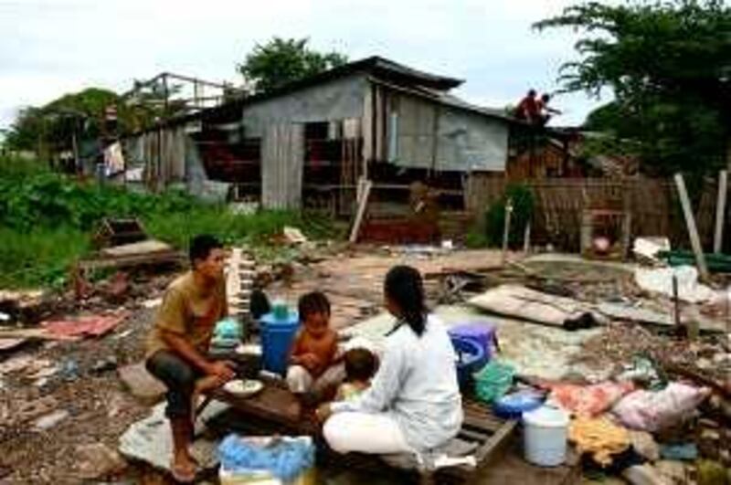CAMBODIA, JULY 2009: A family has breakfast as workers hired by the Phnom Penh municipality demolish homes during a forced eviction on July 17. Jared Ferrie/The National *** Local Caption ***  Ferrie-Donors5.JPG