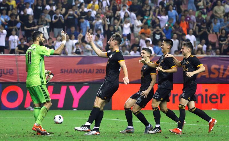 Soccer Football - Premier League Asia Trophy - Wolverhampton Wanderers v Manchester City - Hongkou Football Stadium, Shanghai, China - July 20, 2019  Wolverhampton Wanderers' Rui Patricio celebrates with team mates after making the decisive save of the penalty shootout  REUTERS/Thomas Peter