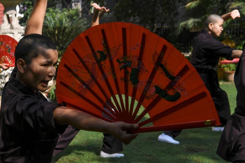 Members of the Kung Fu Nuns group demonstrate their skills in New Delhi.  All photos by AFP