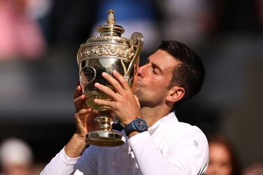 LONDON, ENGLAND - JULY 10: Novak Djokovic of Serbia kisses the trophy following his victory against Nick Kyrgios of Australia during their Men's Singles Final match on day fourteen of The Championships Wimbledon 2022 at All England Lawn Tennis and Croquet Club on July 10, 2022 in London, England. (Photo by Ryan Pierse / Getty Images)