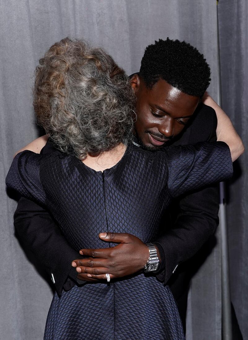 Youn Yuh-jung and Daniel Kaluuya hug outside the press room at the Academy Awards in Los Angeles, California. Reuters