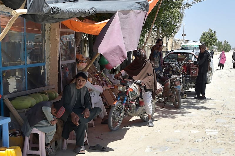 In this photo taken on June 3, 2021, Taliban fighters stand along a road with their motorcycles at a local bazaar in the Andar district of Ghazni province. With Afghan troops in retreat and soon to lose vital US air support, Taliban commanders are voicing exuberance about quickly seizing full control of the country and re-establishing their version of an Islamic state.
 - TO GO WITH AFGHANISTAN-CONFLICT-TALIBAN,FOCUS BY JAY DESHMUKH
 / AFP / WAKIL KOHSAR / TO GO WITH AFGHANISTAN-CONFLICT-TALIBAN,FOCUS BY JAY DESHMUKH
