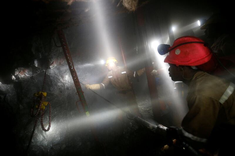 FILE PHOTO: Mine workers employed at Sibanye Gold's Masimthembe shaft operate a drill in Westonaria, South Africa, April 3, 2017. Picture taken April 3, 2017. REUTERS/Mike Hutchings/File Photo