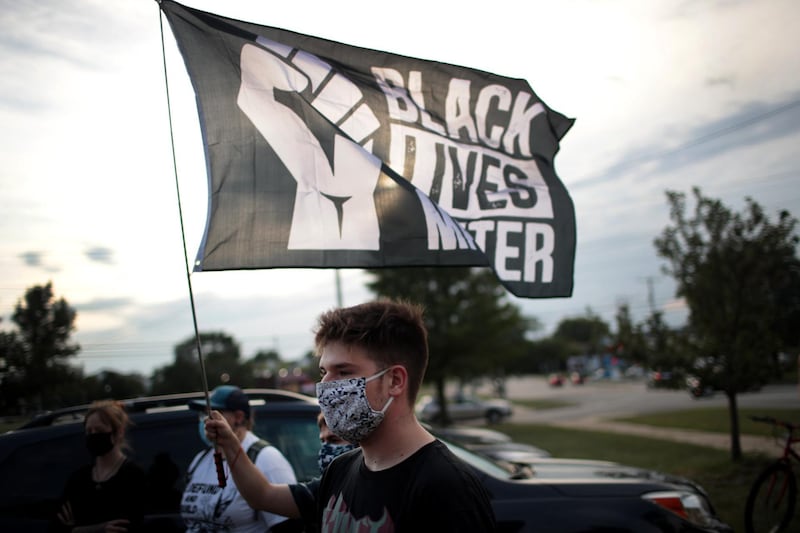 KENOSHA, WISCONSIN - AUGUST 28: A small group of peaceful demonstrators protesting the shooting of Jacob Blake hold a rally on August 28, 2020 in Kenosha, Wisconsin. Blake was shot seven times in the back in front of his three children by a police officer. The shooting has led to several days of rioting and protests in the city.   Scott Olson/Getty Images/AFP
== FOR NEWSPAPERS, INTERNET, TELCOS & TELEVISION USE ONLY ==
